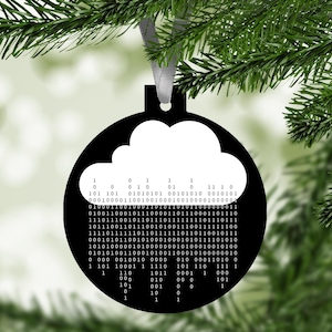 May include: A black and white Christmas ornament shaped like a cloud with a binary code pattern. The cloud is white and the background is black.