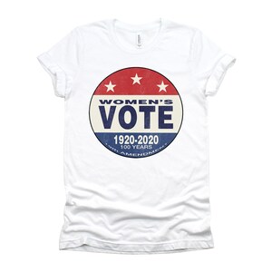 May include: White t-shirt with a red, white, and blue circular graphic that says "Women's Vote 1920-2020 100 Years 19th Amendment."