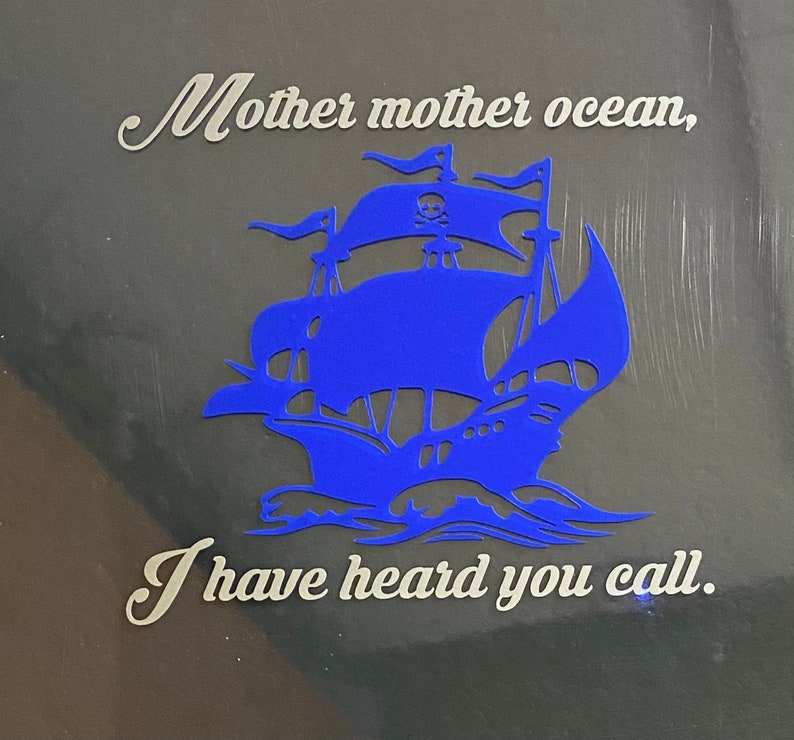 May include: A blue silhouette of a pirate ship with a skull and crossbones on the sail. The text "Mother mother ocean, I have heard you call." is written in white on a dark background.