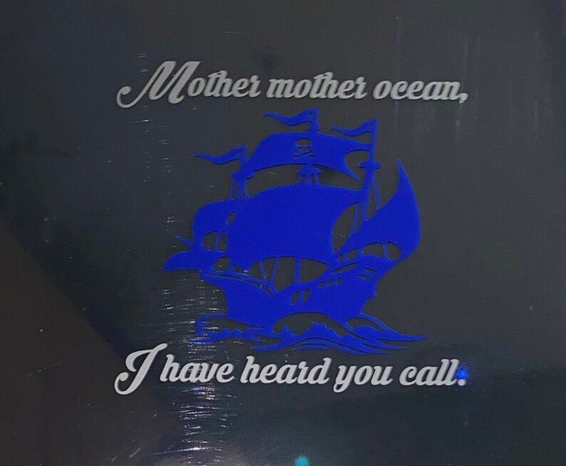 May include: A blue silhouette of a ship with the text "Mother mother ocean, I have heard you call." on a black background.