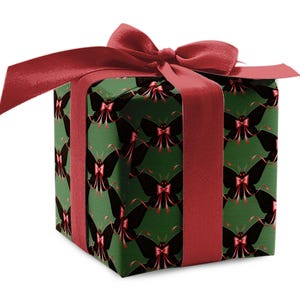 May include: A wrapped gift box with a dark green background and a repeating pattern of black butterflies with red bows. The box is tied with a wide, red satin ribbon and a large bow on top.