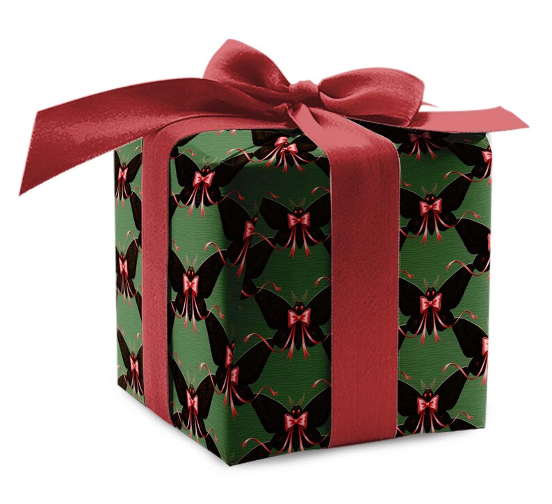 May include: A wrapped gift box with a dark green background and a repeating pattern of black butterflies with red bows. The box is tied with a wide, red satin ribbon and a large bow on top.