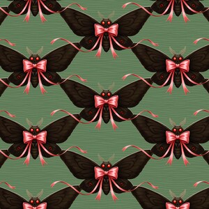 May include: A repeating pattern of dark brown moths with pink bows and red eyes on a green background. The moths have detailed wing patterns and long, flowing ribbons extending from the bows. The background has a subtle, textured appearance.