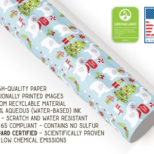 May include: Christmas-themed wrapping paper featuring a light blue background with white elephants wearing Santa hats, Christmas trees, and gift boxes. The paper is made in the USA and Greenguard certified.