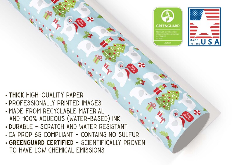 May include: Christmas-themed wrapping paper featuring a light blue background with white elephants wearing Santa hats, Christmas trees, and gift boxes. The paper is made in the USA and Greenguard certified.