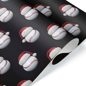 May include: Wrapping paper featuring a repeating pattern of baseballs wearing Santa hats. The baseballs are white with red stitching, and the hats are red with white trim. The background is a dark gray color.