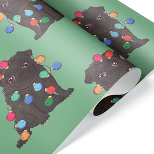May include: Wrapping paper featuring a repeating pattern of black pugs adorned with colorful Christmas lights on a green background. The pugs are illustrated in a cartoon style, with large eyes and a playful expression. The paper is partially rolled.