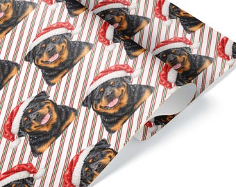 Può includere: Carta da regalo con un motivo ripetuto di teste di cane Rottweiler che indossano cappelli da Babbo Natale rossi e bianchi, su uno sfondo di sottili strisce diagonali rosse e verdi su una superficie bianca.