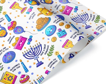 May include: White wrapping paper with a repeating pattern of Hanukkah-themed illustrations. The design includes menorahs, dreidels, candles, and text such as "Enjoy Hanukkah!" and "Wishing you happiness!"