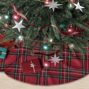 May include: A decorated Christmas tree with ornaments, lights, and a red plaid tree skirt. The tree is adorned with red and teal ornaments, star-shaped decorations, and wrapped gifts.