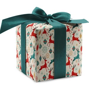 May include: A wrapped gift box with a teal bow and ribbon. The gift wrap features a pattern of red and teal reindeer, snowflakes, and ornaments on a cream background. The box is square-shaped.