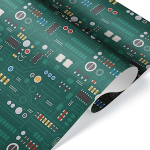 May include: A roll of wrapping paper with a green circuit board design. The pattern includes various electronic components in red, yellow, blue, and white, with a network of lines. The paper is partially unrolled, revealing a white interior.