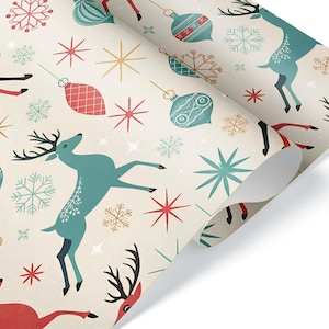 May include: Christmas-themed wrapping paper featuring a repeating pattern of teal and red reindeer, snowflakes, and ornaments on a cream background. The paper is rolled up, showing the design on the top layer.