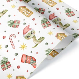 May include: White wrapping paper with a repeating pattern of cartoon snakes wearing Santa hats, Christmas stockings, gifts, candy canes, and stars. The illustrations are in shades of green, red, yellow, and brown.