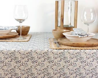 Coated cotton tablecloth from the Vosges region with blue flowers. Rectangular, square, oval, and round tablecloths, custom sizes. Made in France.