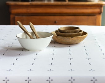 French cotton tablecloth from the Vosges. Gray petals on a white background.