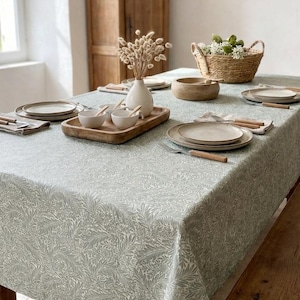 Coated tablecloth. Green foliage.