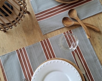 Black and brown/red striped coated cotton placemats on white background