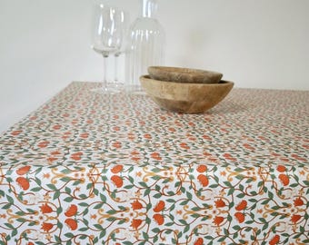 French coated tablecloth - orange floral pattern on white background