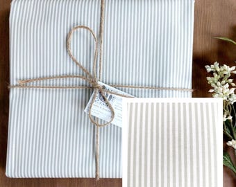 Coated tablecloth in Vosges cotton with white and beige stripes.