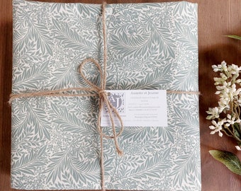 Coated tablecloth. Green foliage.