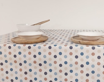 Blue and beige polka dot coated tablecloth on a “cream” background