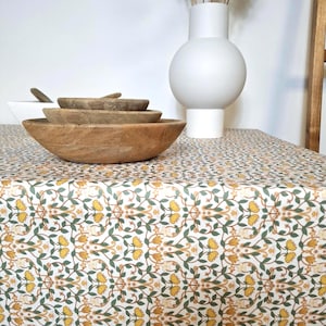 Coated cotton tablecloth from the Vosges with green and yellow floral pattern