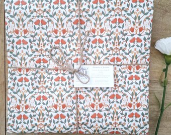 French coated cotton tablecloth from the Vosges – orange floral pattern on a white background – Durable, waterproof and easy to maintain
