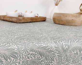 Coated tablecloth. Green foliage.