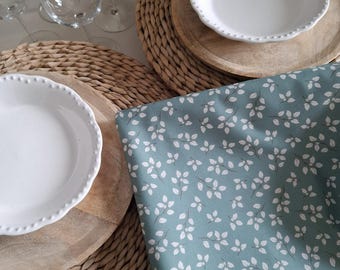 Vosges cotton tablecloth. White flowers on a green background.
