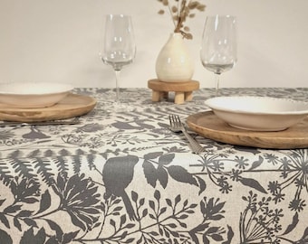 Coated tablecloth with grey-blue foliage. Ecru background