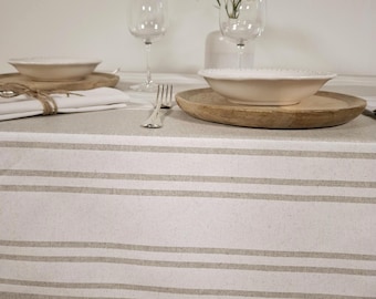 Coated tablecloth with white stripes on a light grey background