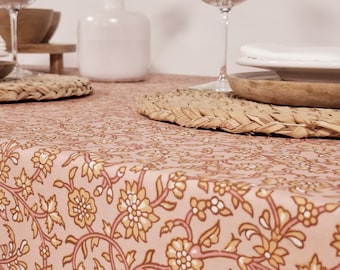 Coated tablecloth with white and yellow flowers on a pink background