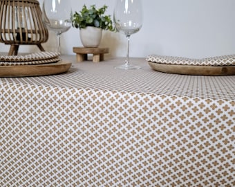 Caramel-colored cotton tablecloth with small geometric patterns