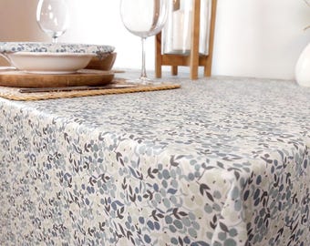 Coated cotton tablecloth from the Vosges region with blue flowers. Rectangular, square, oval, and round tablecloths, custom sizes. Made in France.