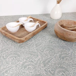 Coated tablecloth. Green foliage.