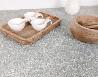 Coated tablecloth. Green foliage.