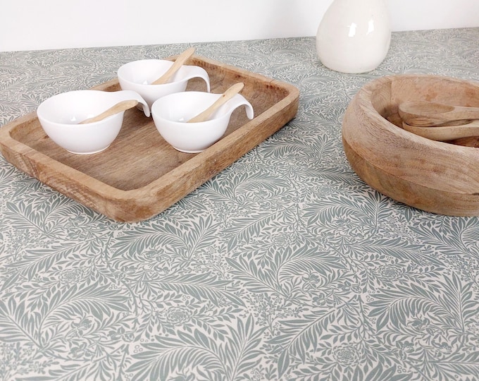 Featured listing image: Coated tablecloth. Green foliage.