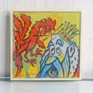 May include: A vintage framed picture with a colorful illustration of a rooster and a crowned figure. The rooster is red and yellow, and the figure is blue and white.