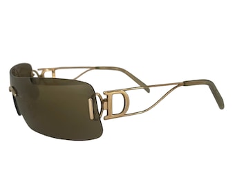 May include: Gold-tone sunglasses with brown lenses and a distinctive double 'D' design on the frame.