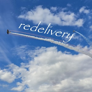 May include: Two small airplanes flying in a bright blue sky with white clouds, creating a long, swirling white smoke trail that forms the word redelivery in a cursive script font against the expansive backdrop of the atmosphere.
