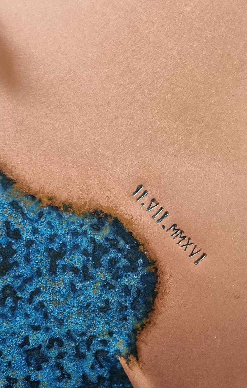 A close up image of the Blue Patina Copper Wall Clock the the engraving II.VII.MMXVI. The clock is made by Copper, Brass and Bronze and Empire Copper by Hayes Home.