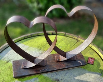 Two hearts made of barrel ring on a piece of whisky barrel stave