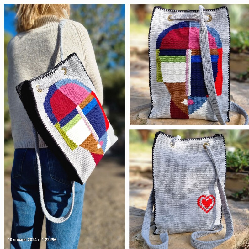May include: A gray crochet backpack with a black trim and a colorful abstract design on the front. The design features geometric shapes in red, pink, blue, green, and brown. The bag has a drawstring closure and shoulder straps.