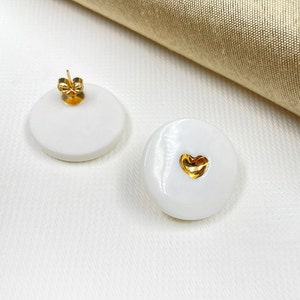 White porcelain studs earrings, with a heart in the middle, hand-painted with pure gold. A perfect wedding porcelain anniversary gift. Featured in BRIDES magazine. Ready for a gift-giving.