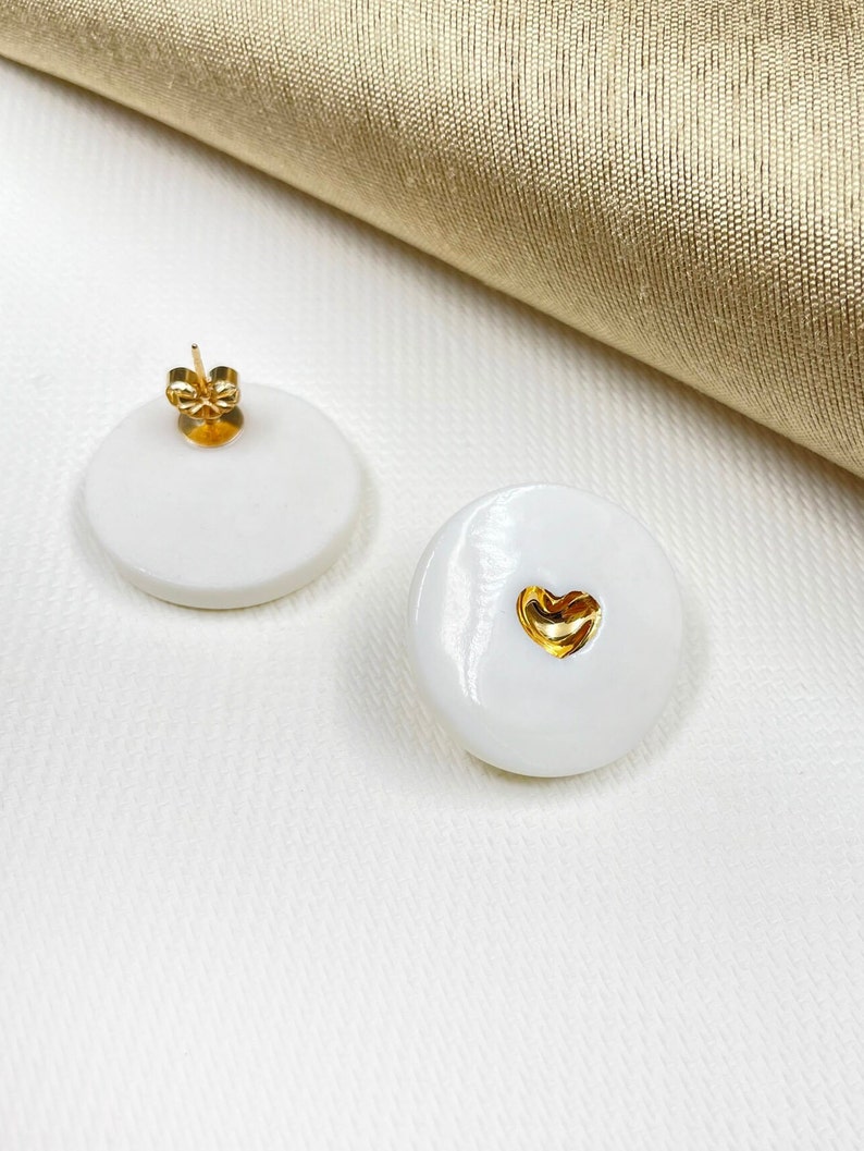 White porcelain studs earrings, with a heart in the middle, hand-painted with pure gold. A perfect wedding porcelain anniversary gift. Featured in BRIDES magazine. Ready for a gift-giving.