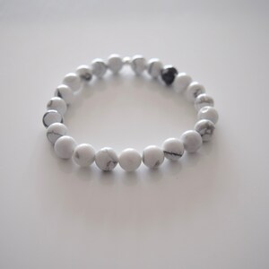 May include: A white howlite beaded bracelet with a silver clasp.