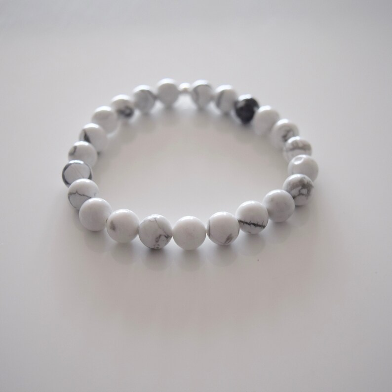 May include: A white howlite beaded bracelet with a silver clasp.