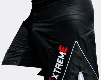 May include: Black athletic shorts with a white and red "EXTREME" logo on the side. The shorts have a white stripe down the side and a white drawstring.