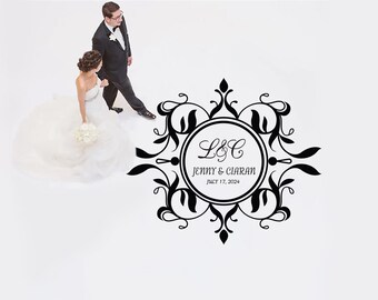 May include: Black and white wedding monogram with a decorative floral design. The monogram features the initials "L&C" and the names "Jenny & Ciaran" with the date "July 17, 2024".